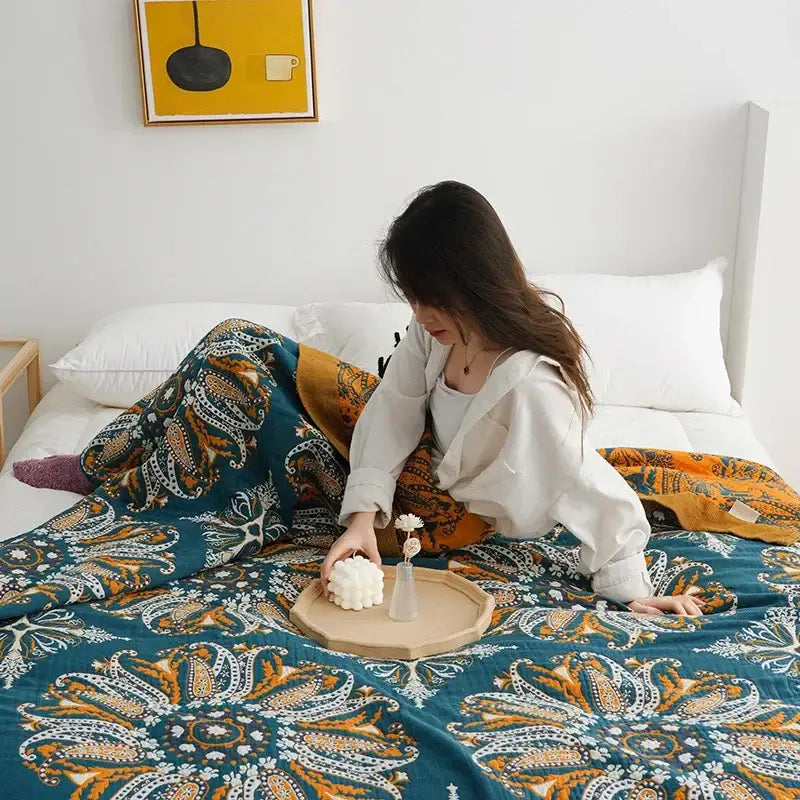 Teal and gold paisley-patterned plush blanket complementing decorbites geometric cotton gauze summer bedroom throw
