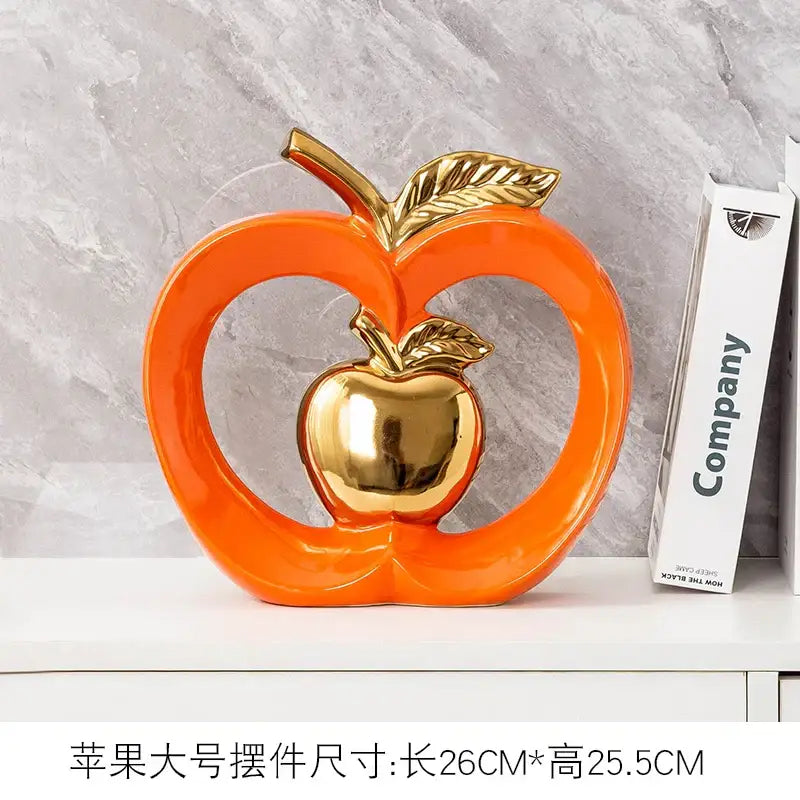 Teal and orange gold plated ceramic apple storage box with orange ceramic apple ornament and metallic gold accents