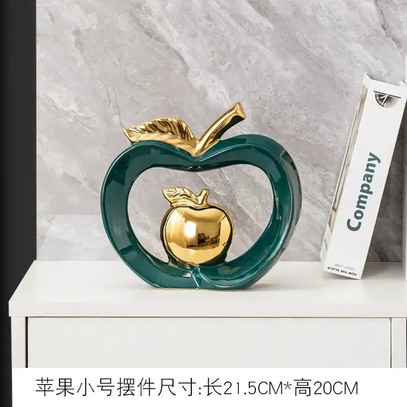 Teal and orange gold plated ceramic apple storage box with glossy finish and open heart design for living room storage