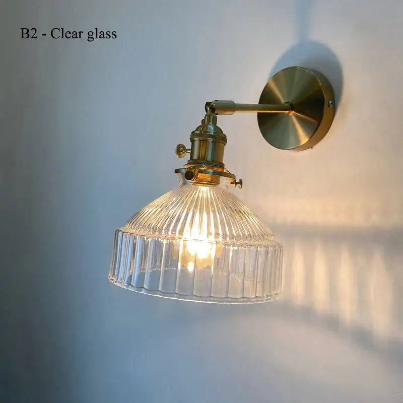 Clear glass ribbed wall lamp with brass hardware featuring a glass shade led design for luxury living room decor