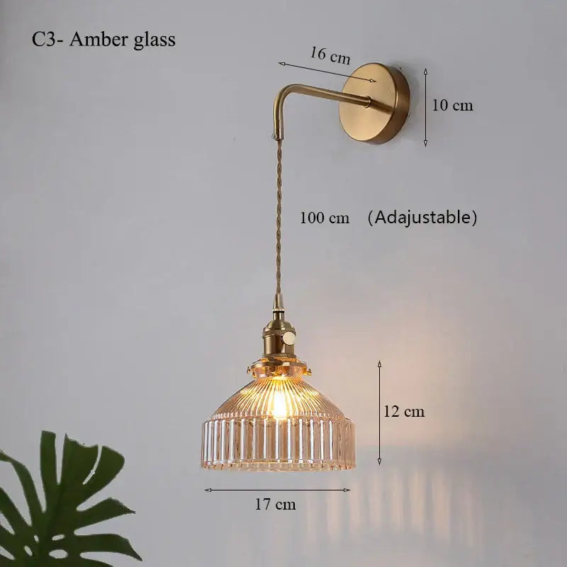 Amber glass shade led wall lamp with vertical ridges and brass-finished chain for luxury living room decor