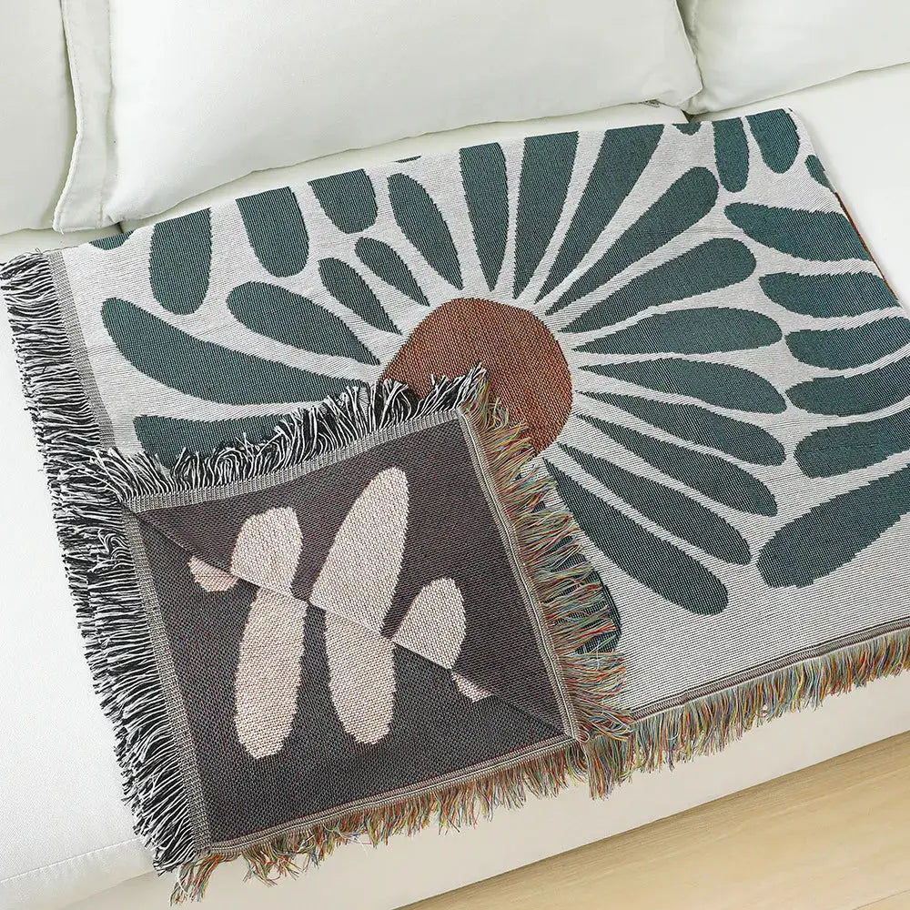 Cozy throw blanket with decorbites daisy pattern woven design in teal and tan featuring fringed edges for living room decor