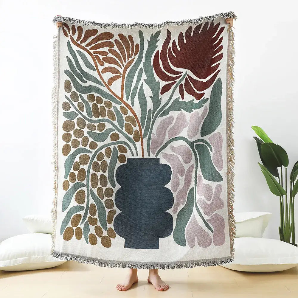 Cozy cream throw blanket with decorbites daisy pattern woven in rust, sage, dusty rose, and navy for living room decor