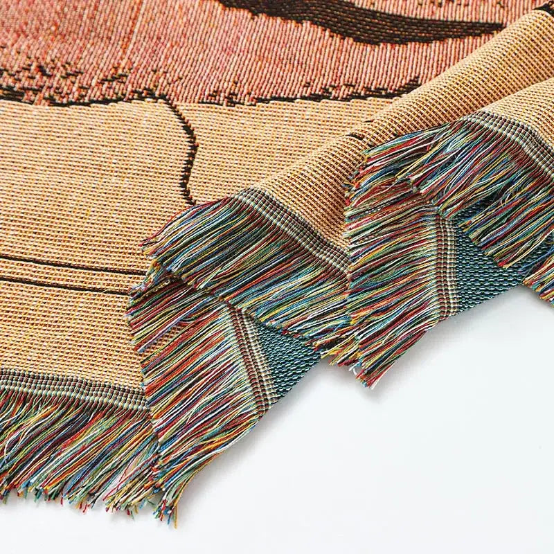 A woven tapestry knitted nordic outdoor sofa blanket with earthy tones and multicolored fringe for living room decorbites decor