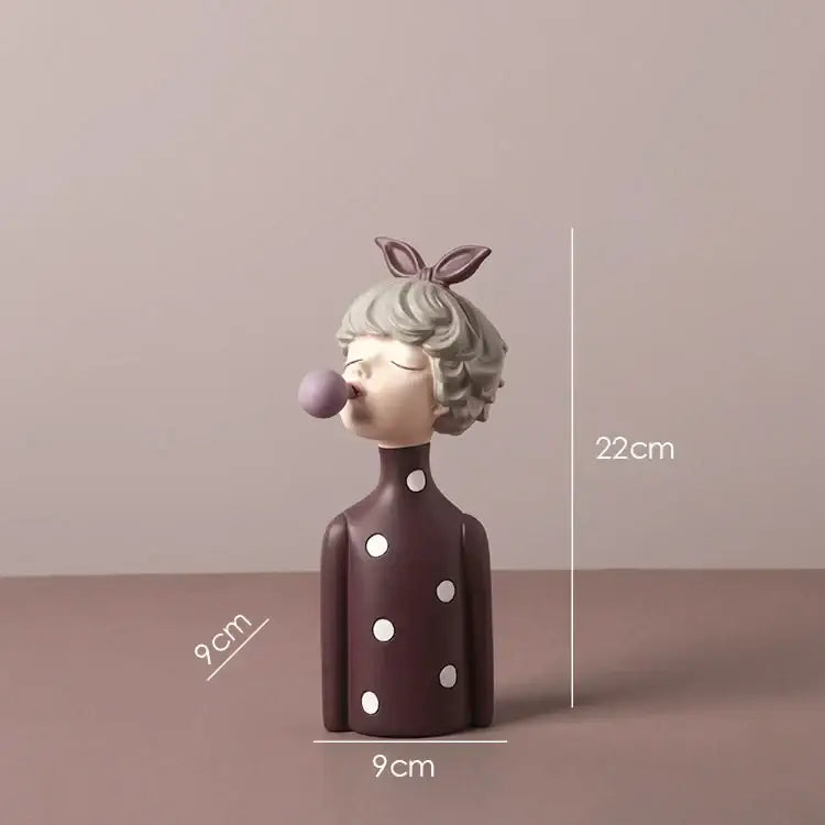 A matte brown bowknot girl resin figurine with white polka dots blowing a purple bubble gum in a gold tray decorbites bowknot girl