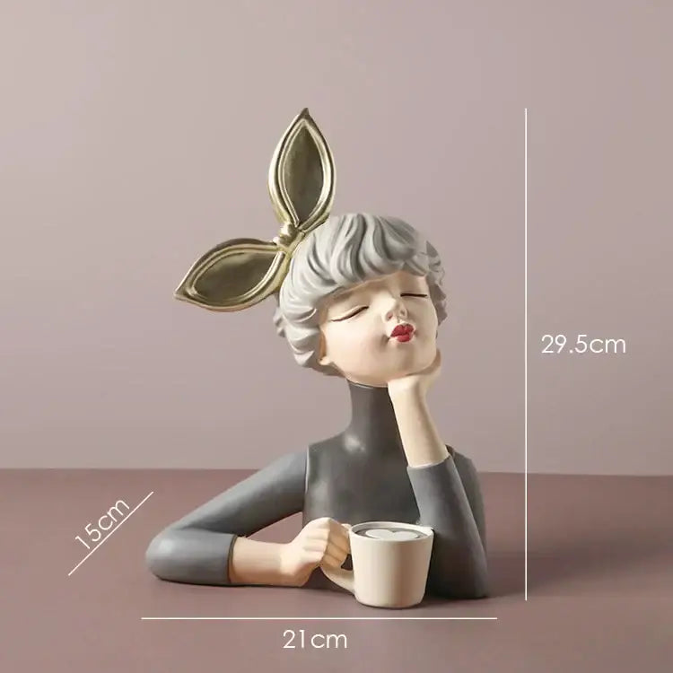 A sleek gray bowknot girl resin figurine with silver hair and gold leaf headpiece holding a white mug on gold tray decorbites bowknot girl