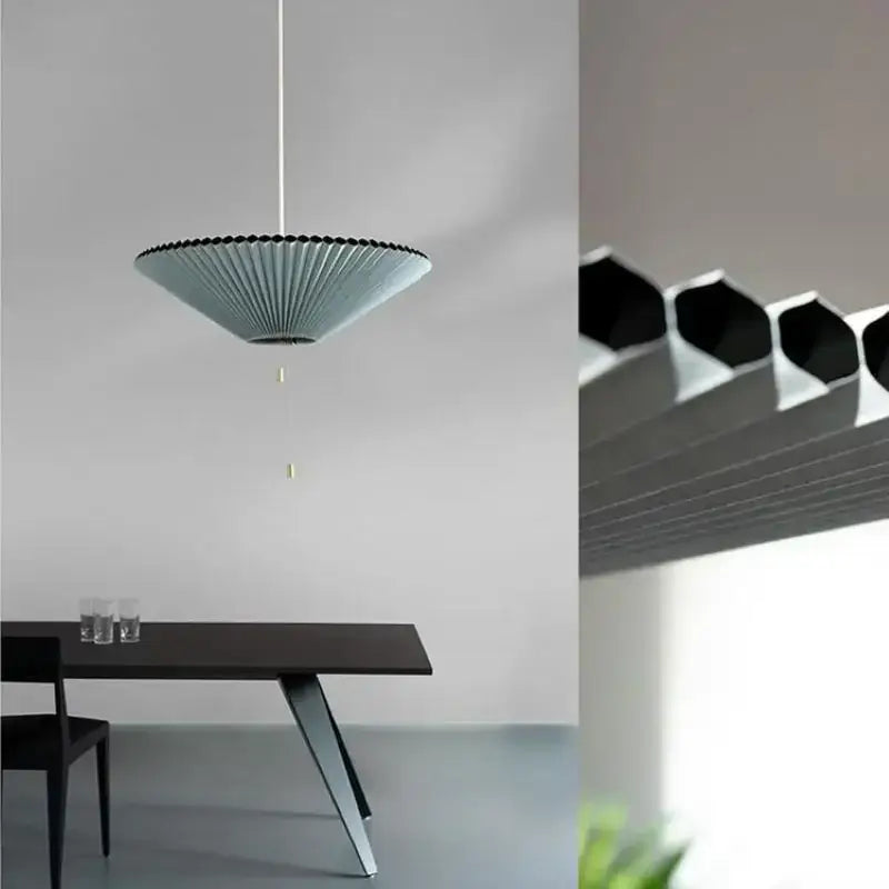 A modern light blue pleated decorbites deformed fabric umbrella pendant lamp with black rim and white cord for dining room