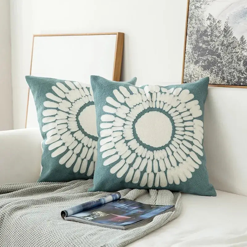 Teal cushion cover with white embroidered geometric floral sunburst pattern for living room decor