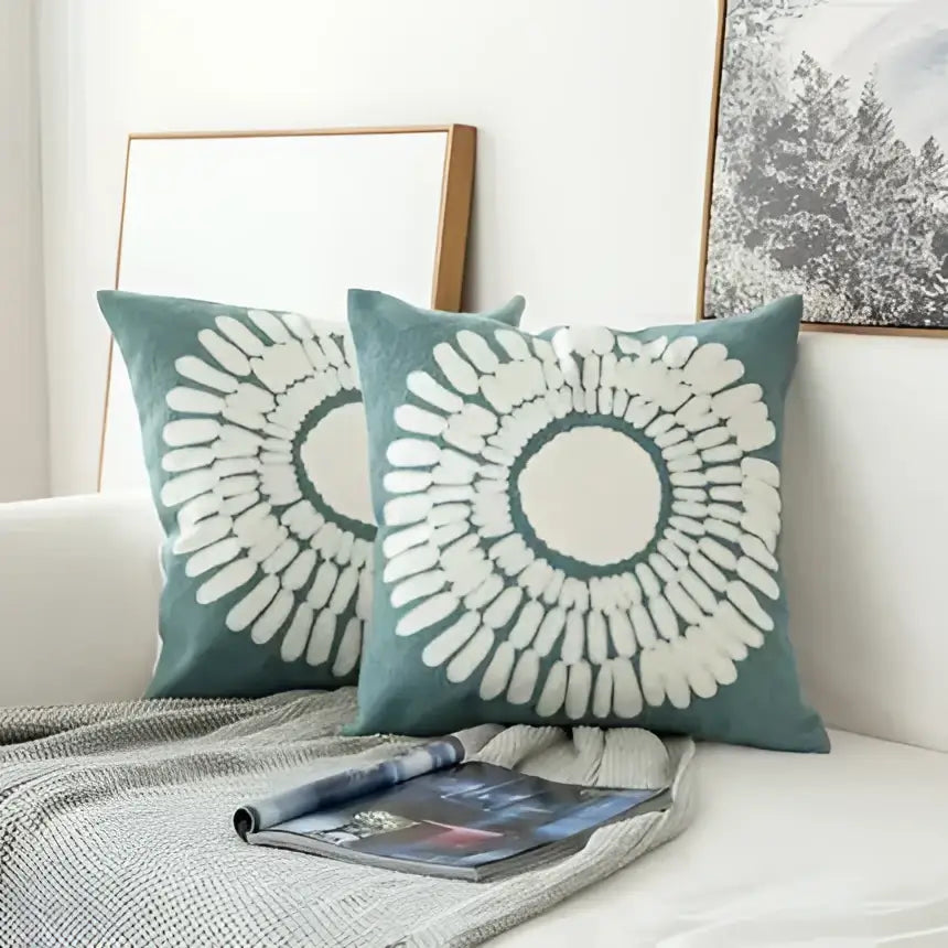 Teal cushion cover with white embroidered geometric floral sunburst pattern for living room decor