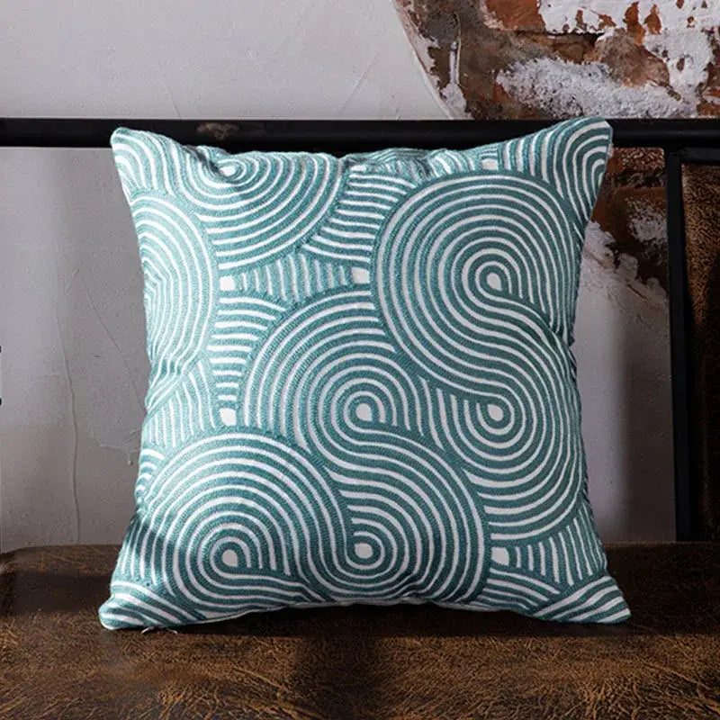 Teal and white blue geometric embroidered cushion cover with swirling pattern for living room decor by decorbites
