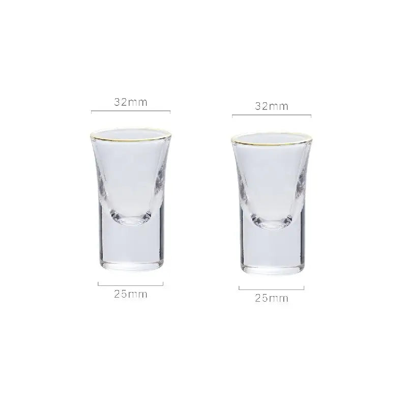 Clear glass shot glasses with gold rim and etched details complementing the teardrop glass wine pot for dining room and bar