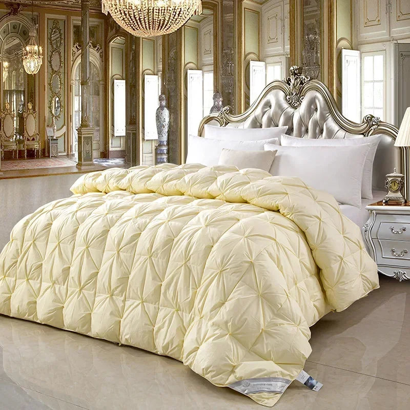 Cream-colored quilted temperature controlled down quilt with diamond stitch pattern made of white goose down