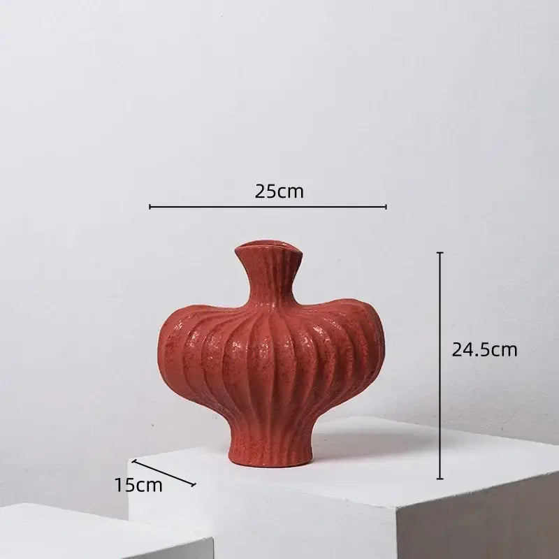 A terracotta-colored ceramic fringe heterophore vase with a ribbed bulbous body and narrow neck for living room decor