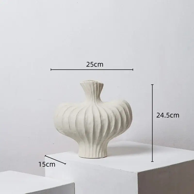 A white ceramic fringe heterophore vase with ribbed bulbous body and fluted neck for living room decorbites decor