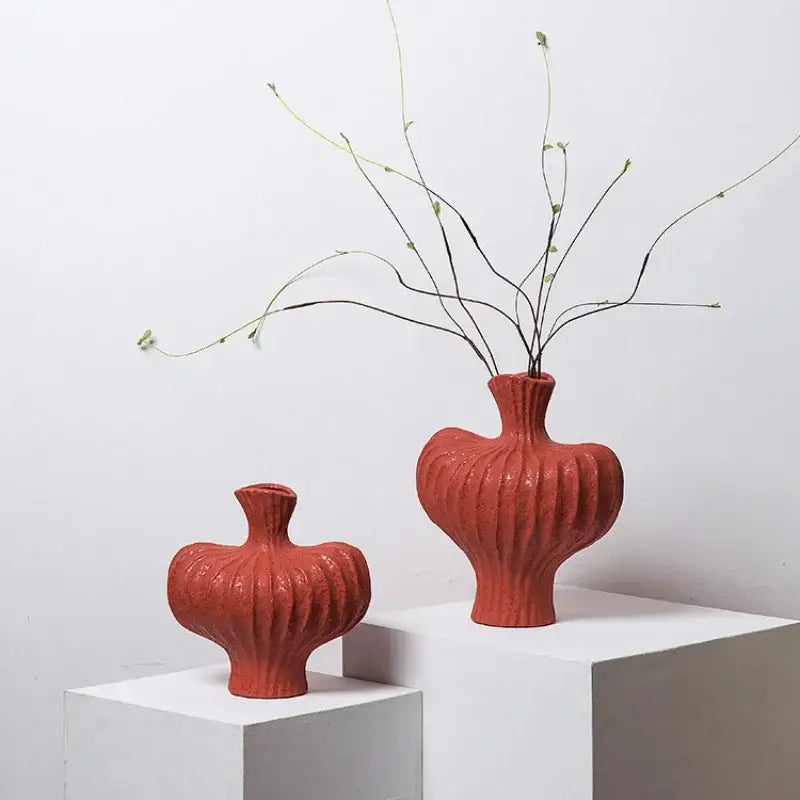 Two terracotta-colored ceramic fringe heterophore vases with ribbed textures ideal for living room decorbites fringe heterophore decor