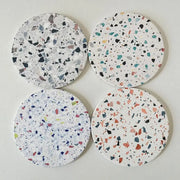 Set of four decorbites diatomite coasters with white terrazzo base and multicolor fragments for dining room use