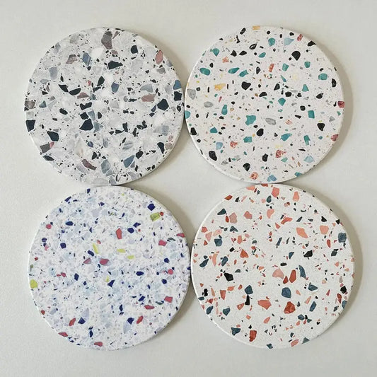 Set of four decorbites diatomite coasters with white terrazzo base and multicolor fragments for dining room use