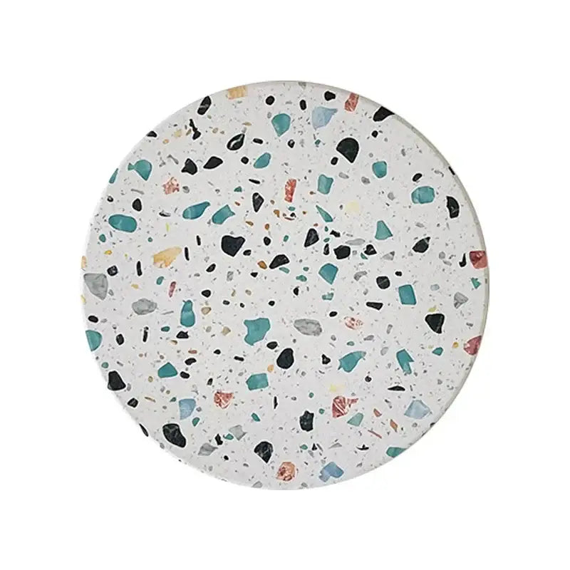 Circular terrazzo decorbites diatomite coaster with white base and teal black gray yellow muted pink specks for dining mugs