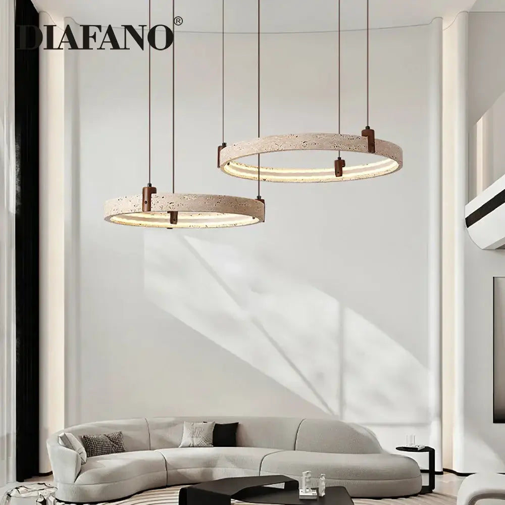 Modern circular pendant light with textured beige concrete finish and warm LED illumination decorbites cave stone chandelier