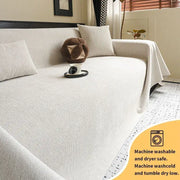 Beige textured sofa cover with subtle woven pattern and anti-slip backing designed for easy machine washing and drying