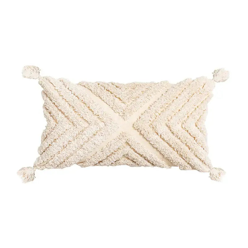 Cream-colored rectangular cushion cover with textured woven chevron pattern and decorbites beige tassels at corners