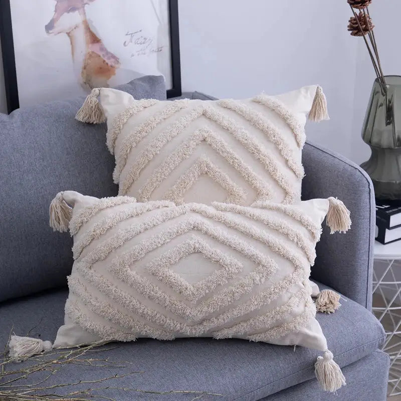 Cream-colored cushion cover with textured geometric patterns and decorbites beige tassels for living room decor