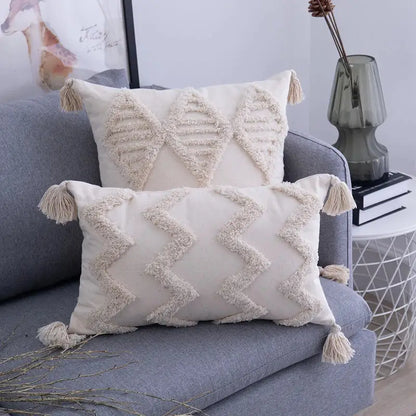 Cream-colored rectangular cushion cover with textured woven geometric patterns and decorbites beige tassels edges