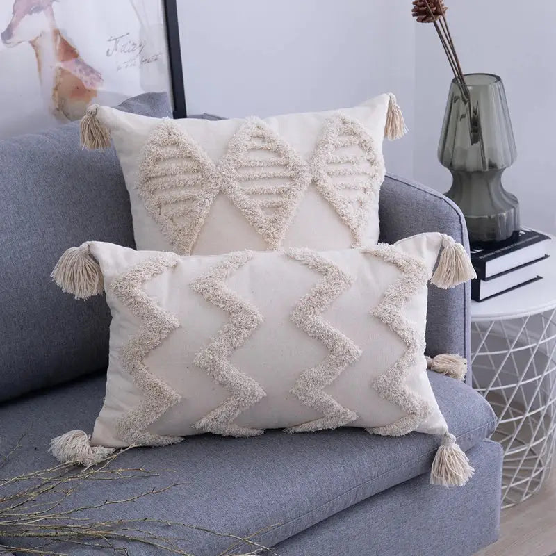 Cream-colored rectangular cushion cover with textured woven geometric patterns and decorbites beige tassels edges