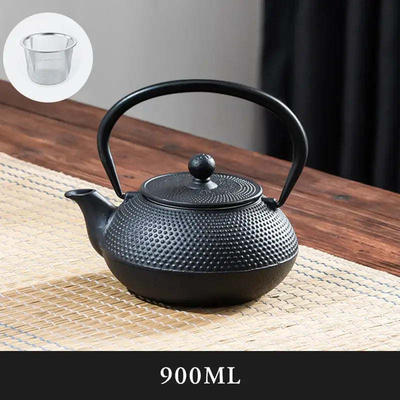 Textured black cast iron tea pot with dimpled surface and rounded handle perfect for kitchen steeping
