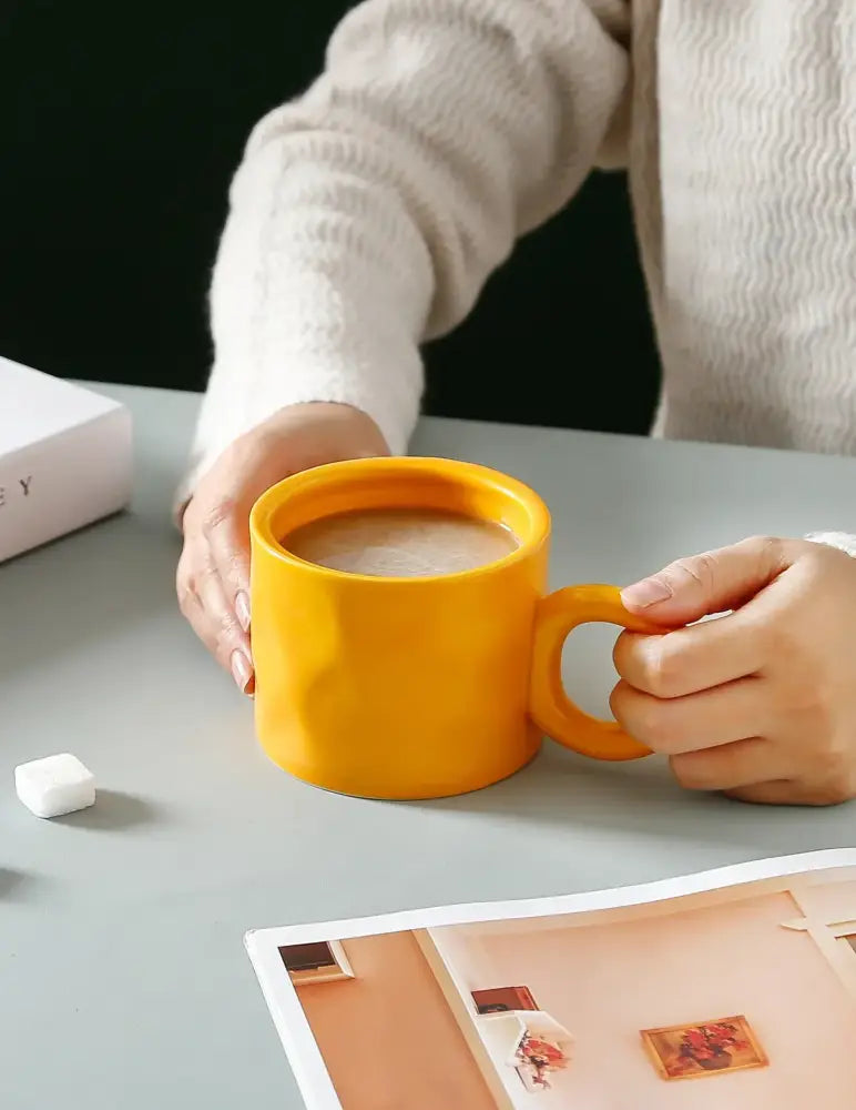 Vibrant yellow ceramic coffee mug with smooth glossy finish and sturdy handle for everyday use