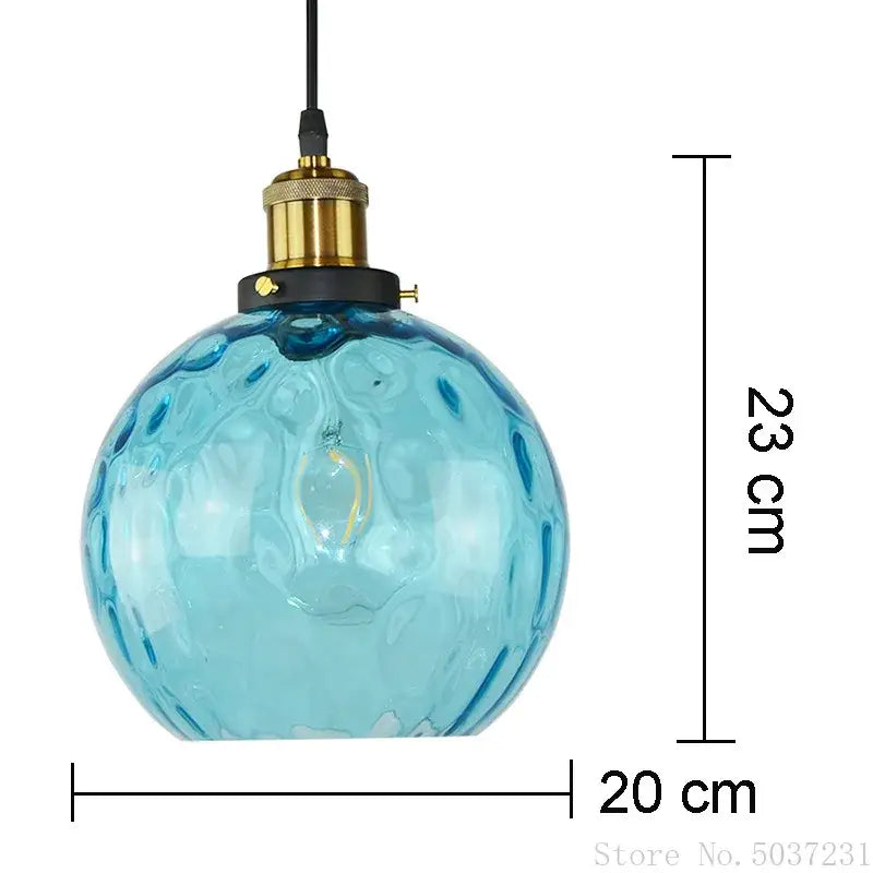 Textured blue glass ball pendant light with translucent bubble surface and brass socket for dining room decorbites blue glass