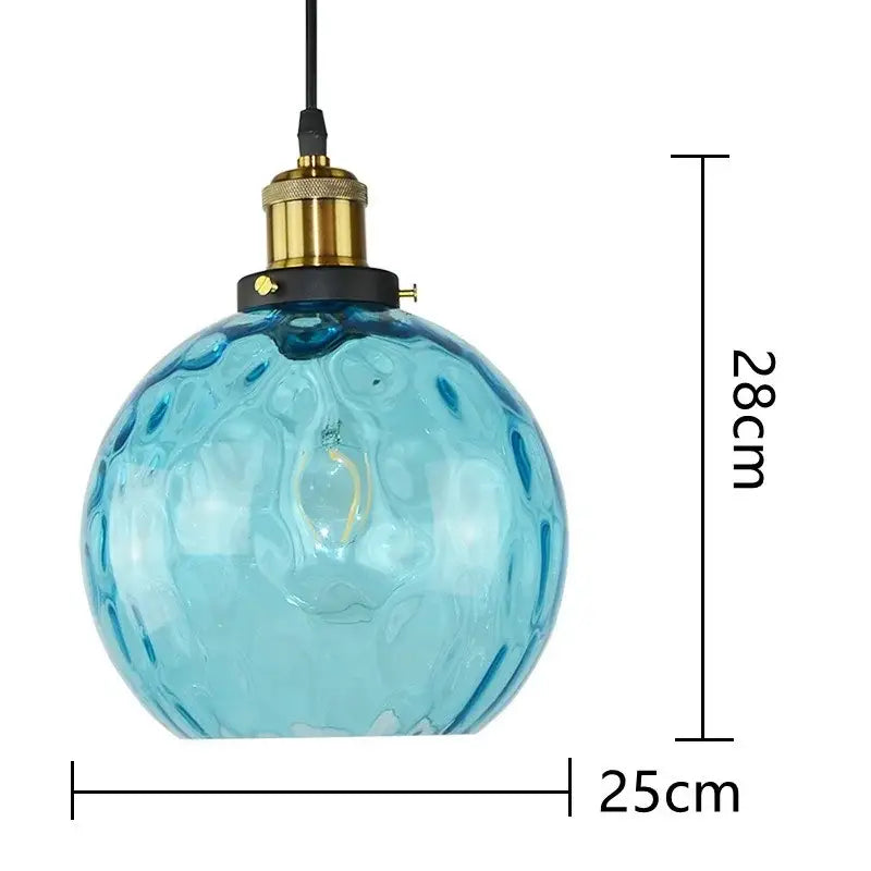 Textured blue glass ball pendant light with translucent bubble surface and brass holder for dining room decorbites blue glass