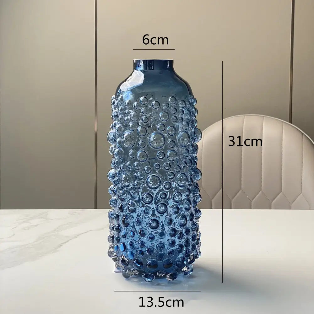 A tall translucent blue glass flower vase with textured bubble surface ideal for living room decorbites clear glass display