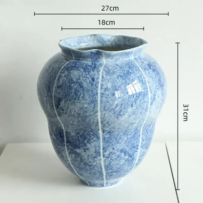 Textured blue and white ceramic vase hydroponic with marbled glaze and vertical white lines mimicking lotus pod segments
