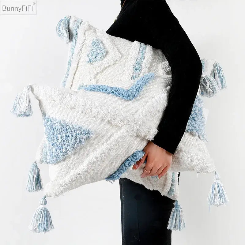 Textured blue and white geometric cushion cover with tassels featuring a white and light blue textured throw pillow decorbites blue geometric design