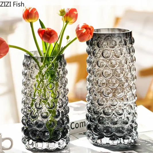 Two textured bubble glass hydroponics plant pots with orange tulips and one empty for living room table use