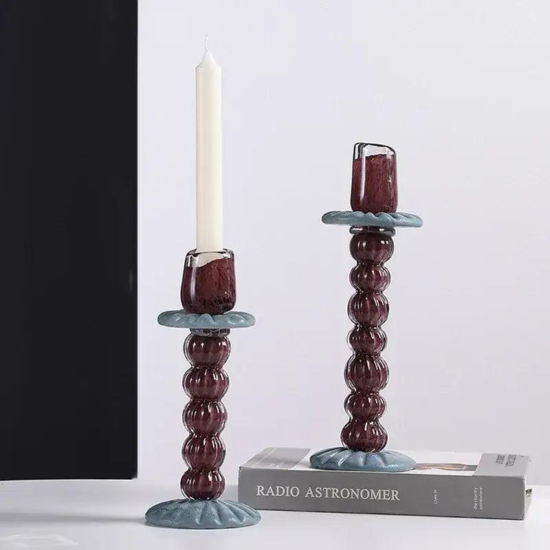 Deep burgundy geometric glass candlestick holder with textured beaded design and light blue ceramic base for dining room decorbites