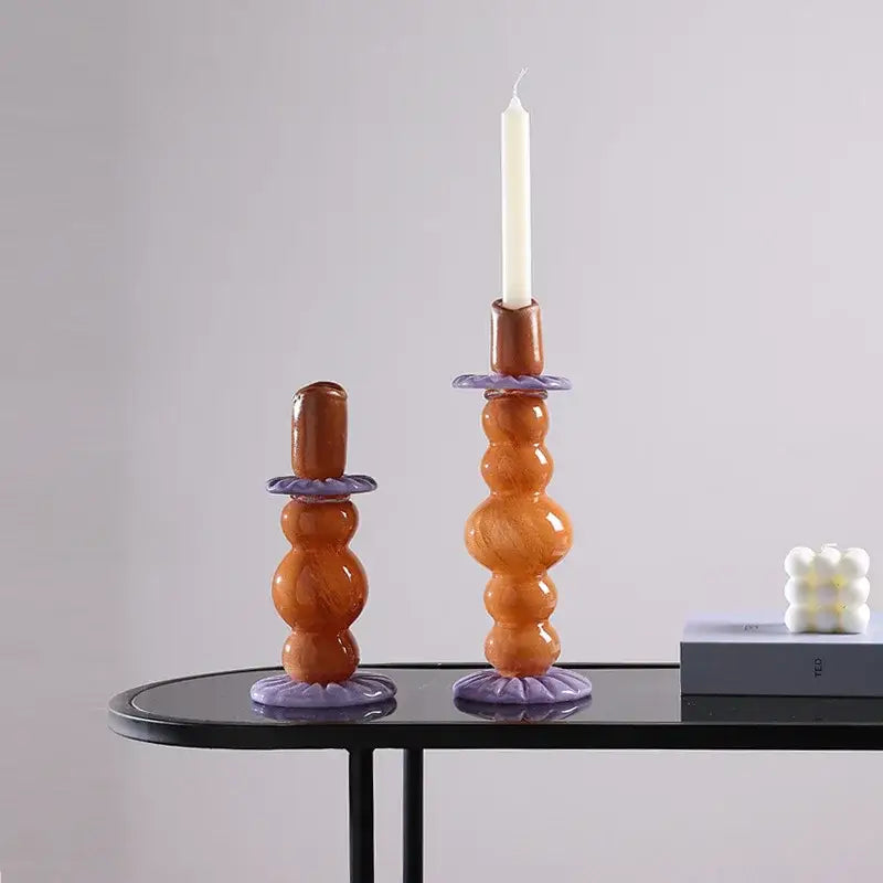 Tall amber glass candlestick holder with purple ceramic bases and decorative rings for decorbites geometric glass decor