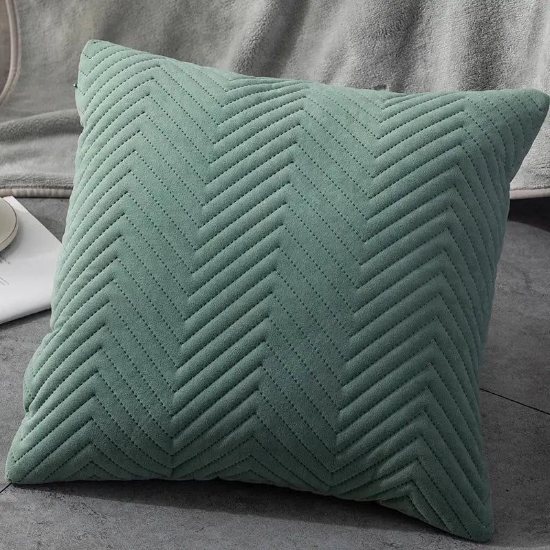 A soft sage green quilted cushion cover with textured chevron pattern ideal for decorbites blue wave living room decor