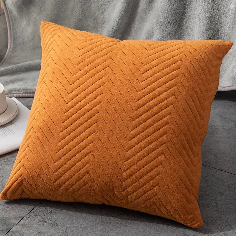 A plush orange cushion with textured chevron quilting ideal for decorbites blue wave cushion cover and blue wave crimping decor