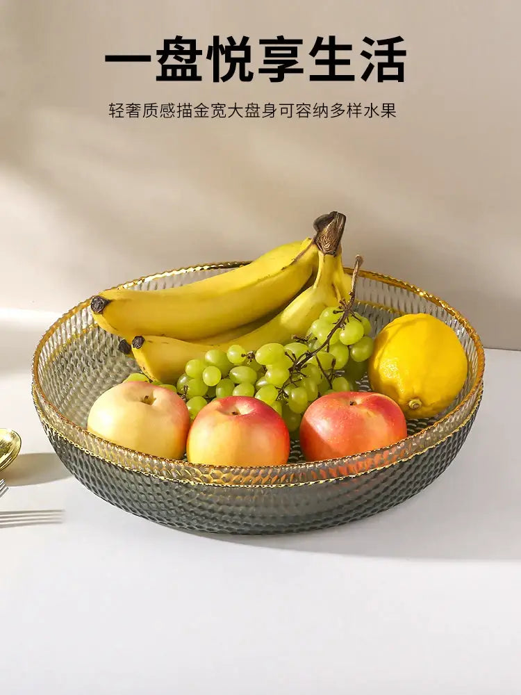 A sleek dark gray textured glass fruit plate with gold rim and woven pattern for snack storage