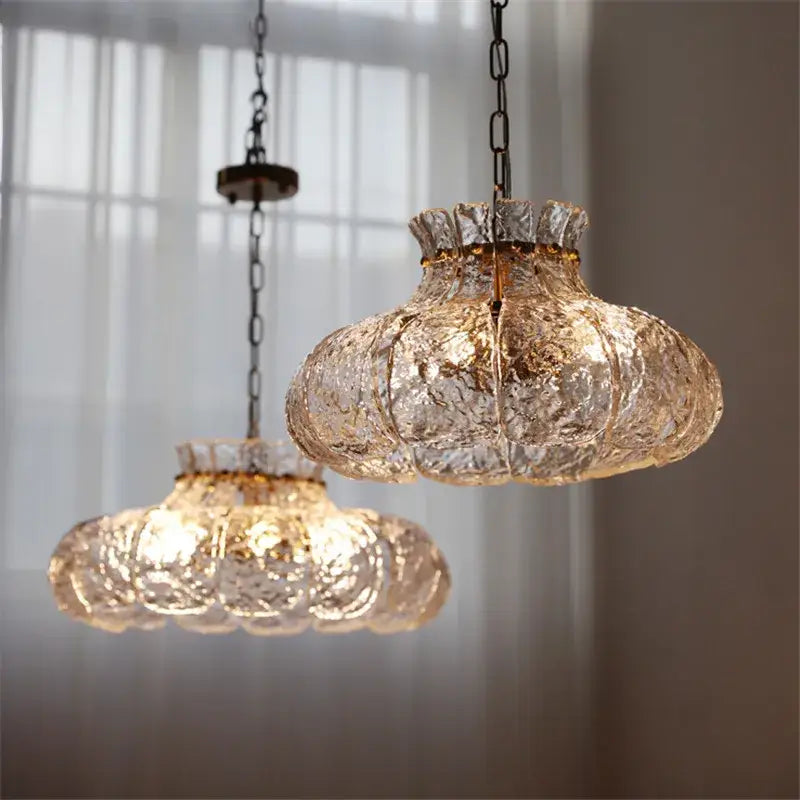 Two vintage-style textured clear glass french pendant lights with dark metal chains for dining room chandelier