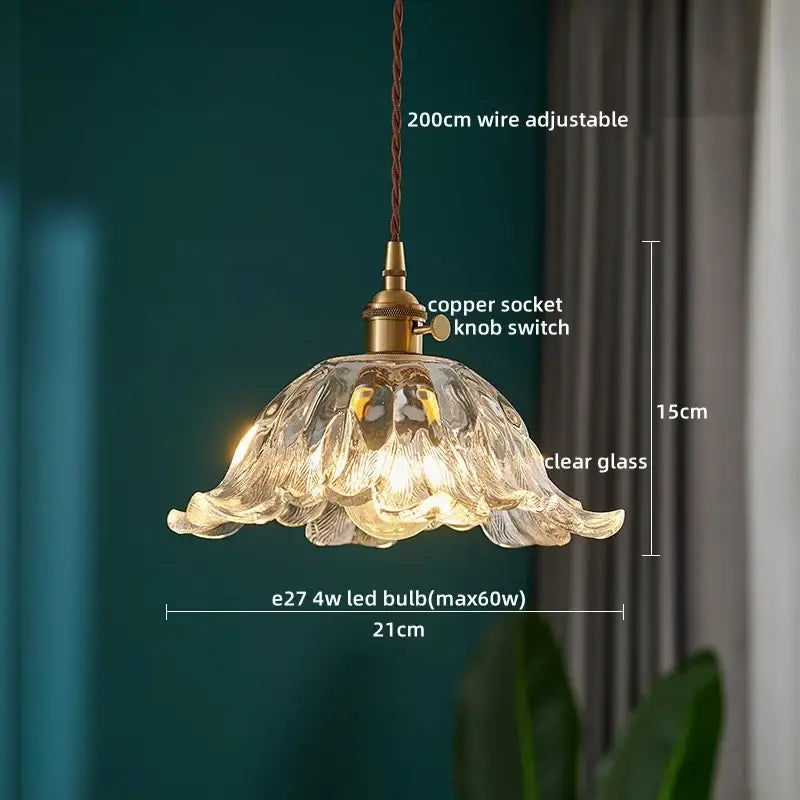 A delicate clear glass led pendant light with fluted petal design and brass decorbites clear glass kitchen fixture