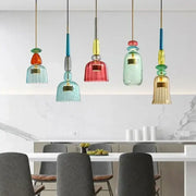 Colorful glass pendant lights with textured bell-shaped shades in teal red and gold for kitchen dining chandelier