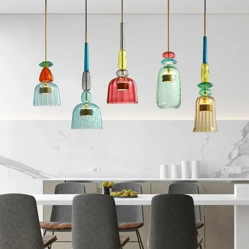 Colorful glass pendant lights with textured bell-shaped shades in teal red and gold for kitchen dining chandelier