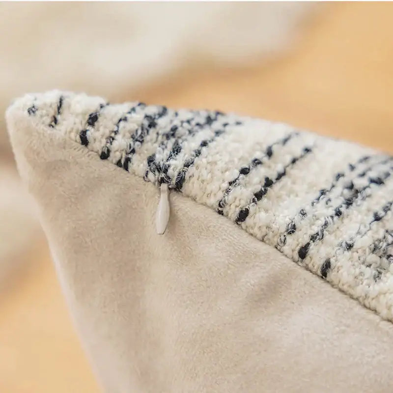A cozy cream comfort woolen pillow cover with black and white stripes and a white zipper pull for living room decorbites comfort woolen pillow