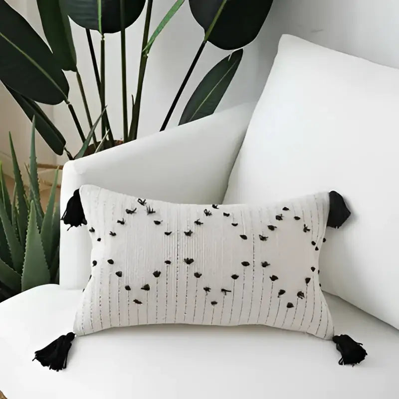 Beige woven cushion cover with black tassels and embroidered heart pattern for decorbites geometric tassels decor