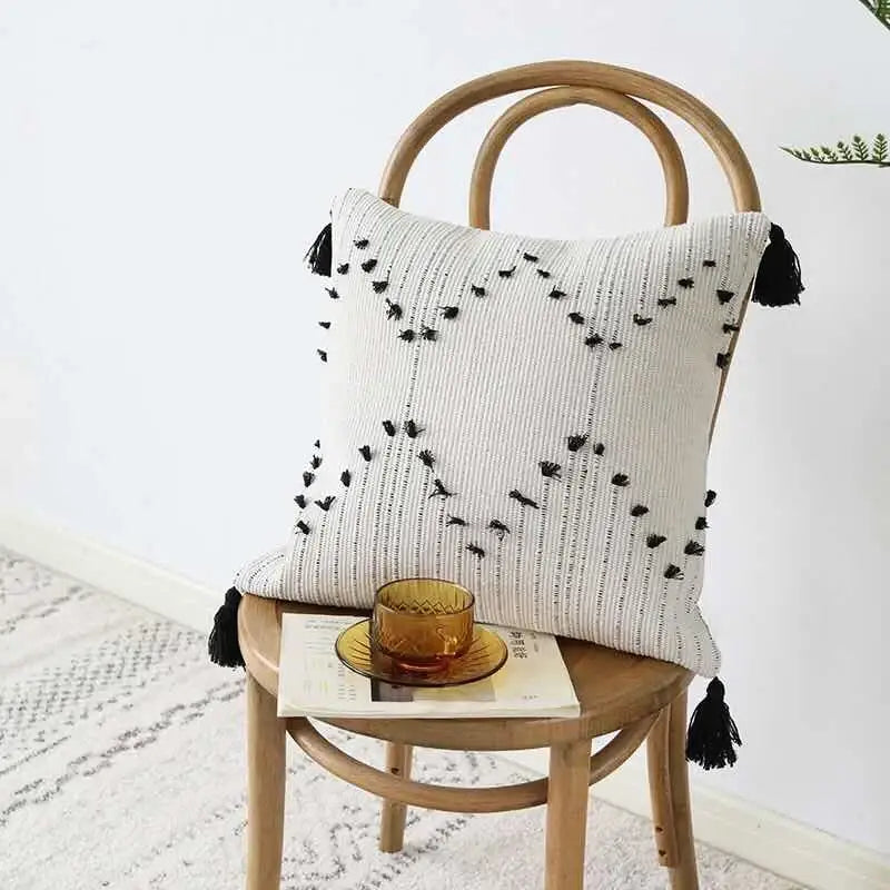 Off-white textured cushion cover with black geometric tassels and embroidered bird motifs for living room decorbites geometric tassels