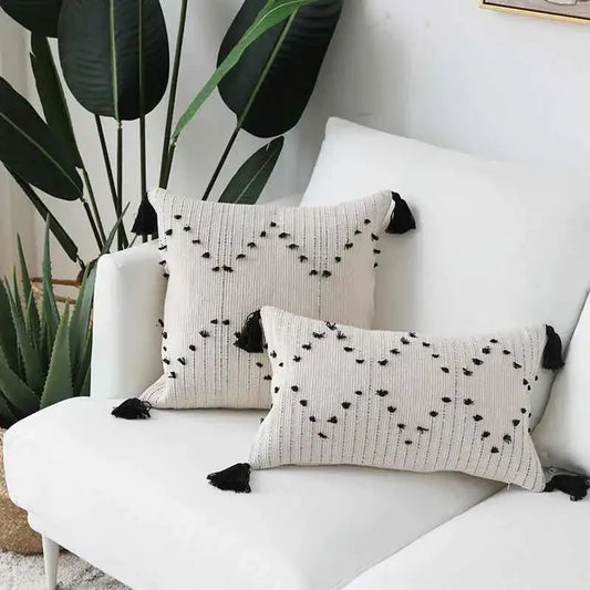 Cream-colored cushion cover with black geometric tassels and textured woven pattern for living room decorbites decor
