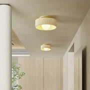 Cream ceiling light with textured surface and gold-toned metallic trim providing warm diffused glow for living room decorbites cream ceiling
